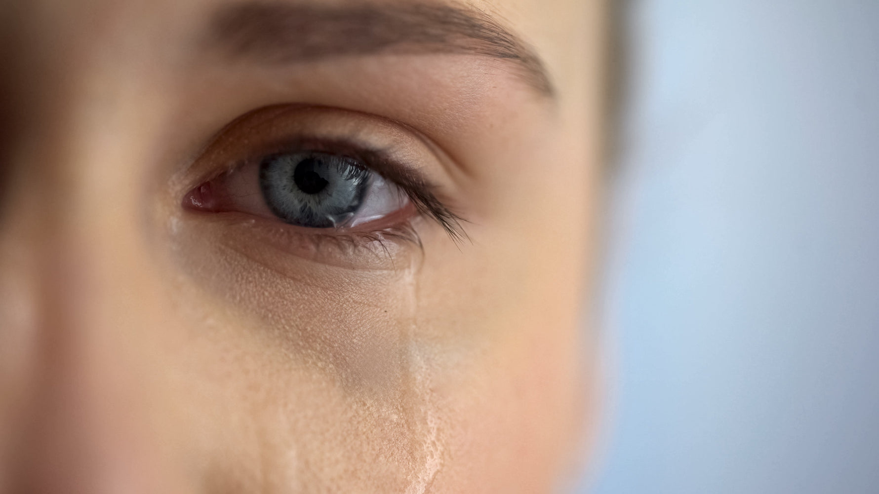 woman crying single left eye with tears