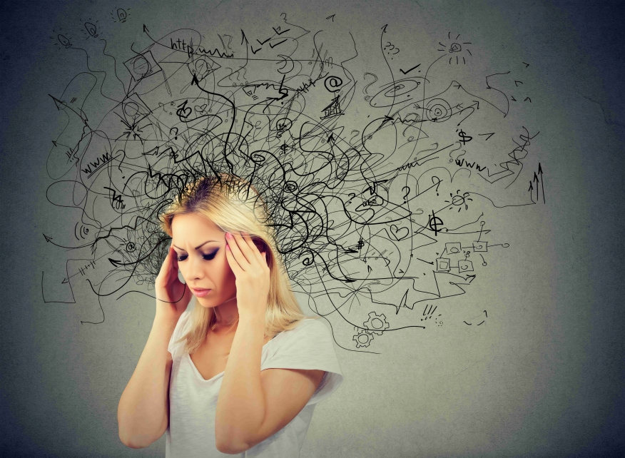 Stressed woman who is overthinking and has a mess of thoughts in her head