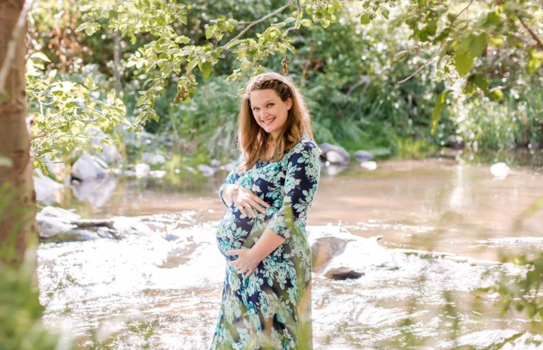 Pregnant mama showing her bump in nature
