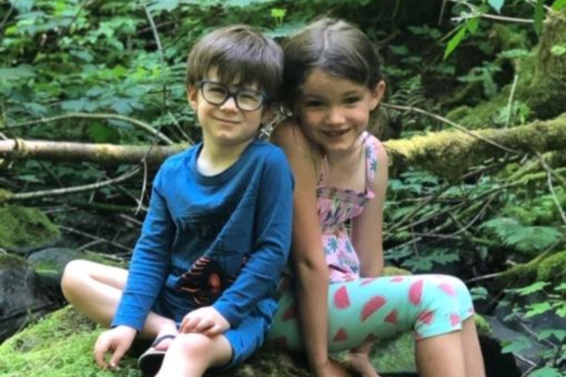 Two children sitting outdoors