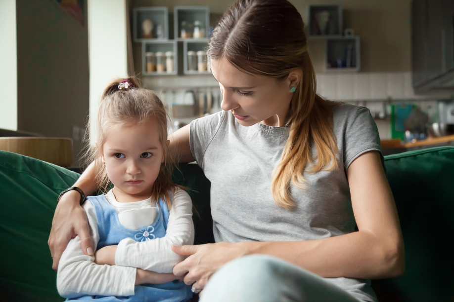 the mother is handling speaking and trying to  manage her child emotions because the child is upset or sad and about to have meltdown