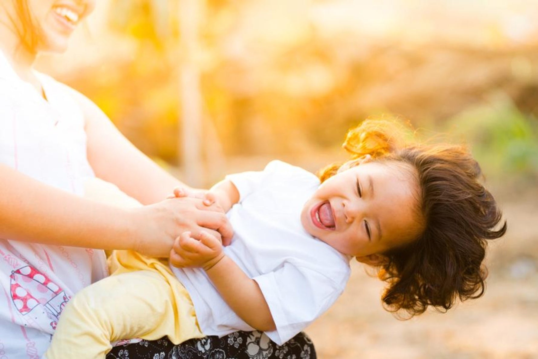 Mother swinging her child